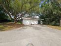 Spacious three-car garage offering ample parking and storage, set under the shade of mature trees at 606 Butler St, Windermere, FL 34786