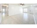 Bright, spacious living room with marble tile flooring and natural light from a window at 6524 Swissco Dr # 1012, Orlando, FL 32822