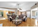 Bright living room featuring hardwood floors and an open layout with views of the kitchen at 9275 Lake Sharp Ct, Orlando, FL 32817