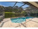 Inviting screened-in pool with clear blue water, and a safety handrail for easy access at 1017 Gould Pl, Oviedo, FL 32765