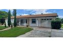 Attractive home with an attached garage, stone accents, and well-maintained front lawn at 10928 Tangora St, Orlando, FL 32825