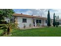 Charming single-story home with a well-maintained front yard, stone accents, and lush landscaping at 10928 Tangora St, Orlando, FL 32825