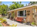 Charming single-story home featuring stone accents, large windows, and outdoor seating at 1104 W Marjorie St, Lakeland, FL 33815