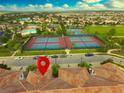 A nice aerial view showcases community amenities, including tennis courts, swimming pool, and lush landscaping at 14164 Swanley St, Orlando, FL 32832