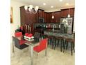 A well-appointed kitchen featuring granite countertops, stainless steel appliances, and dark wood cabinets at 14164 Swanley St, Orlando, FL 32832