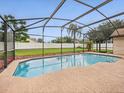 Screened-in pool area with refreshing blue water and ample space for relaxation and entertainment in a backyard setting at 14322 Pine Cone Trl, Clermont, FL 34711