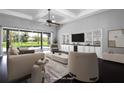 Bright living room with large sliding glass doors, custom built-ins, and dark wood floors at 1441 Foxtail Ct, Lake Mary, FL 32746