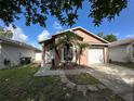 Inviting one-story home with tidy front yard, single car garage, and front door entryway at 1470 Daniels Cove Dr, Winter Garden, FL 34787
