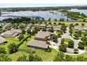 An aerial view showcases houses in a residential area near a lake and lots of green space at 15500 Fountain Cove Ct, Winter Garden, FL 34787
