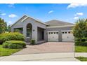 Charming one-story home featuring a brick driveway, a two-car garage, and inviting curb appeal at 15500 Fountain Cove Ct, Winter Garden, FL 34787