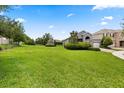 Expansive front lawn leading to a well-kept home with mature landscaping, offering great curb appeal at 15500 Fountain Cove Ct, Winter Garden, FL 34787