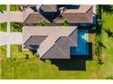 Aerial view of house showing tile roof, pool, backyard and pristine landscaping at 15942 Vetta Dr, Bella Collina, FL 34756