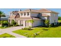 Beautiful two-story home with a tile roof, a two-car garage, and mature landscaping at 15942 Vetta Dr, Bella Collina, FL 34756