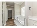Bright bathroom with a soaking tub, white tile, and modern fixtures at 1660 Justin Matthew Way, St Cloud, FL 34771