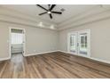 Spacious main bedroom with tray ceilings, ceiling fan and access to the lanai at 1660 Justin Matthew Way, St Cloud, FL 34771