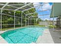 Screened-in pool and patio, surrounded by mature trees, perfect for outdoor enjoyment at 1660 Justin Matthew Way, St Cloud, FL 34771
