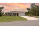 Well-maintained single-story home features a lush lawn, neutral paint, and a two-car attached garage at 16863 Sw 29Th Terrace Rd, Ocala, FL 34473