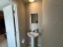 Small bathroom with a sink, toilet, mirror, and beige walls at 1922 Conway Rd # 1922, Orlando, FL 32812