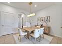 Bright dining area with modern light fixture, seating for six, and contemporary decor at 200 Feltrim Reserve Blvd, Davenport, FL 33837