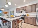 Modern kitchen featuring a large island with seating, stainless steel appliances, and sleek countertops at 200 Feltrim Reserve Blvd, Davenport, FL 33837