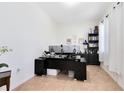 Bright office space with neutral colors, built in bookshelves, and modern black desk at 2071 Remembrance Ave, St Cloud, FL 34769