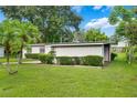 A charming house featuring a unique geometric design and a well-maintained green lawn at 209 Wilmer Ave, Orlando, FL 32811