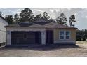 Exterior view of a home under construction, showcasing its frame, windows, and garage at 2292 Broadbrook Drive, St Cloud, FL 34771