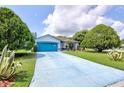 Charming single-story home with a well-maintained lawn and a long blue driveway provides a welcoming entrance at 2334 W Doris St, Kissimmee, FL 34741