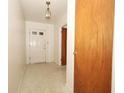 Bright entryway with a front door featuring glass panes and a light fixture, leading into the home at 2417 Bayfront Pkwy, Orlando, FL 32806