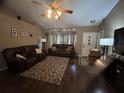 Spacious living room featuring hardwood floors, neutral walls, and two leather couches at 2830 Gramercy Dr, Deltona, FL 32738