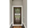 Inviting front door with welcome mat framed by white trim offers a warm entry to the property at 3210 Sonesta Ct # B, Clermont, FL 34711