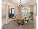 Bright dining room with a modern table, six chairs, a chandelier, and natural light from a large window at 3808 Ocita Dr, Orlando, FL 32837
