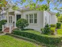 Attractive home featuring manicured hedges and landscaping, enhancing its curb appeal under a clear blue sky at 4545 Fox St, Orlando, FL 32814