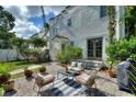 A backyard featuring a patio with stylish outdoor seating and manicured landscaping at 501 Richmond St, Orlando, FL 32806