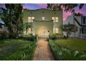 Beautiful two-story home with lush landscaping and a welcoming brick pathway leading to the entrance, perfect for families at 501 Richmond St, Orlando, FL 32806