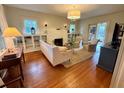 Bright living room featuring a fireplace, built-in bookshelves, hardwood floors, and comfortable seating area at 501 Richmond St, Orlando, FL 32806