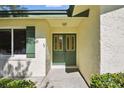 Inviting front entrance featuring a charming green double door with glass panels and a sidelight window at 5334 Cypress Dr, Winter Park, FL 32792