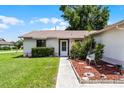 Inviting front entrance with well-maintained landscaping, a walkway, and charming seating area at 5439 E Sacramento Ct, Orlando, FL 32821