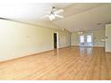 Spacious living room featuring hardwood floors and ample natural light at 5588 Garden Grove Cir, Winter Park, FL 32792