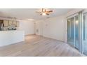 Bright living room with a ceiling fan, tile floors, and a sliding glass door to the patio at 711 Sugar Bay Way # 109, Lake Mary, FL 32746