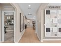 Inviting hallway featuring stylish decor and wood flooring, leading to various rooms in the home at 7408 Olivewood Ave, Orlando, FL 32829