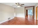 Open-concept living space with wood-look floors and decorative beam accents at 1204 Marie Ave, Apopka, FL 32703