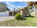 Exterior of home with stone column carport and well maintained lawn at 123 Se 1St Ave, Webster, FL 33597