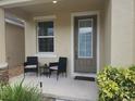 Inviting front porch with cozy seating, creating a welcoming entrance at 129 Boydfield Ln, Davenport, FL 33837