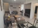 Open-concept living room perfect for entertaining, featuring stylish decor at 129 Boydfield Ln, Davenport, FL 33837