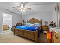 Spacious main bedroom featuring a large bed, an en-suite bathroom, and ample natural light at 135 Inconnu Ct, Kissimmee, FL 34759