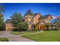 An attractive two-story home showcasing a turret and beautifully manicured front lawn at 1415 Brumley Rd, Chuluota, FL 32766