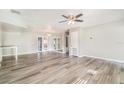 Open living room with sleek hardwood floors and ample natural light, complemented by stylish mirrored wall features at 1422 Russell Ave, Orlando, FL 32806