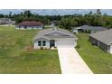 Charming single-story home featuring a two-car garage, well-manicured lawn, and a clean, modern facade at 14322 Sw 28Th Ave, Ocala, FL 34473