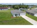 Angle aerial view of the home with a large lawn, and a two car garage at 14322 Sw 28Th Ave, Ocala, FL 34473